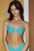 Teal bikini top with underwire cups, thin straps, and cutout detail at center front.